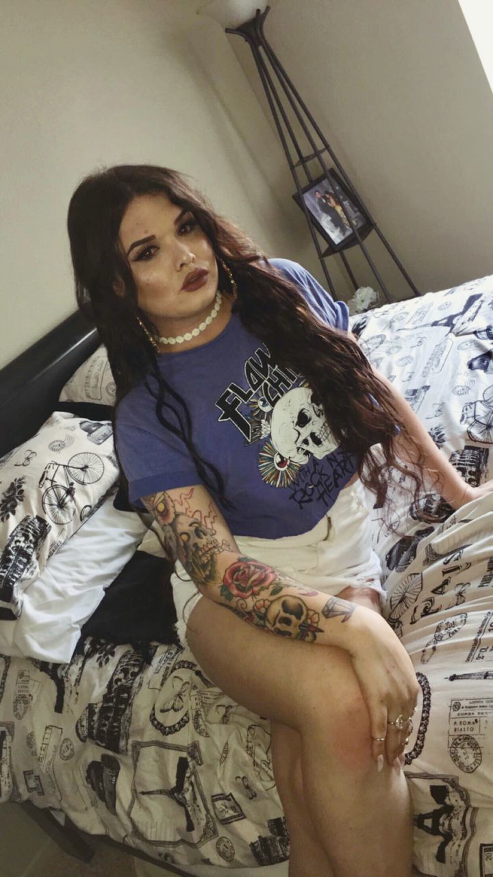 furniture, lifestyles, bed, real people, indoors, young adult, one person, leisure activity, young women, home interior, tattoo, women, front view, casual clothing, adult, bedroom, sitting, relaxation, hairstyle, floral pattern