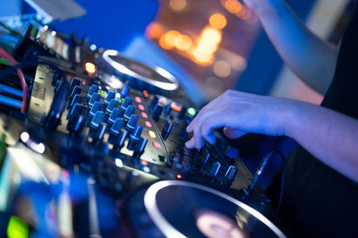 Cropped hand of man playing sound mixer