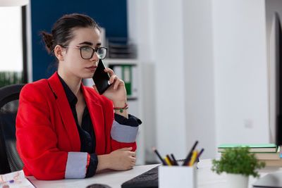 Businesswoman talking on call at office