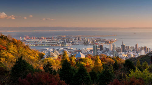 High angle view of trees and buildings against sky during sunset