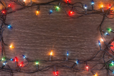 Low angle view of illuminated street lights at night