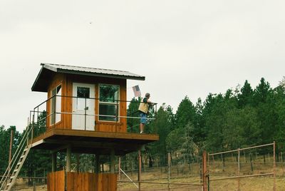 Man against built structure against clear sky