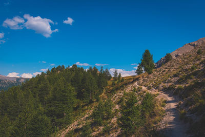 Panoramic view of mountain against blue sky