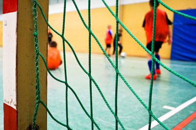 Rear view of sportsperson seen through net