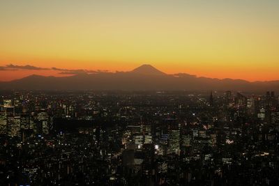 Aerial view of city lit up at night