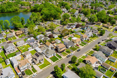 High angle view of trees and houses in city