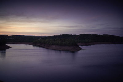 Scenic view of lake against sky at sunset