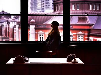 Woman standing by window in restaurant