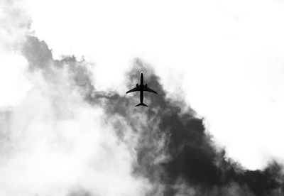 Low angle view of airplane flying in sky