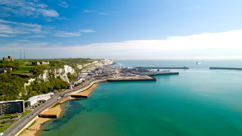 Scenic view of sea and buildings against sky