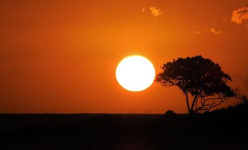 Scenic view of silhouette landscape against orange sky