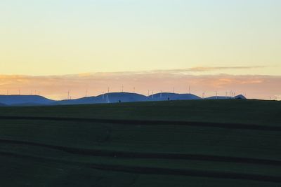 Scenic view of landscape against sky at sunset