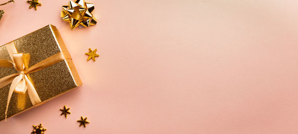 Directly above shot of christmas decorations on pink background