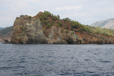 Scenic view of sea and mountains against sky