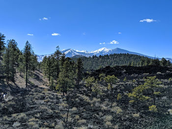 Scenic view of mountains against blue sky