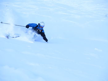 Low angle view of person paragliding against sky