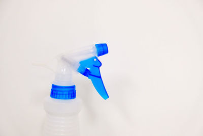 Close-up of blue bottle against white background