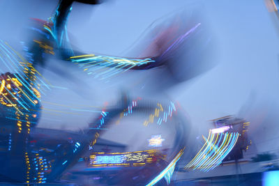 Blurred motion of illuminated carousel in city