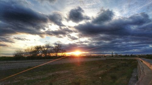 Scenic view of landscape against cloudy sky