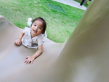 Portrait of a smiling girl lying down