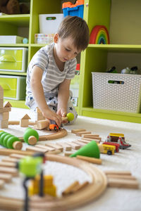 Boy playing with toys at home