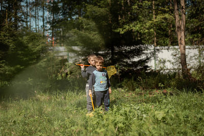 Little boys with butterfly nets in countryside. image with selective focus