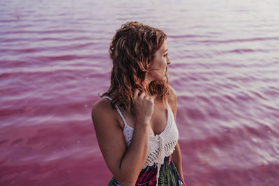 Midsection of woman standing against sea