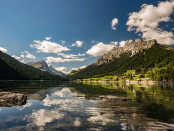 Scenic view of lake and mountains against sky