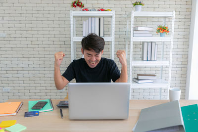 Young woman using laptop at office