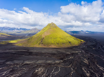 Scenic view of volcano against cloudy sky