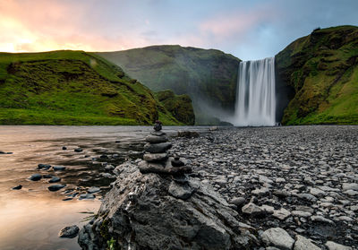 Scenic view of waterfall against sky