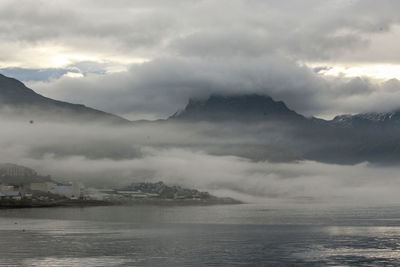 Scenic view of sea and mountains against sky