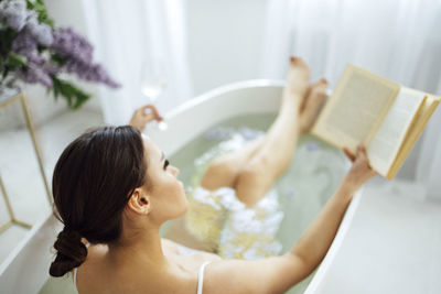 High angle view of mother and daughter in bathroom