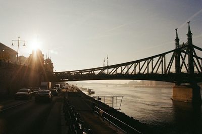 Bridge over river at sunset