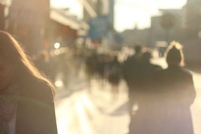 Rear view of women walking on street in city