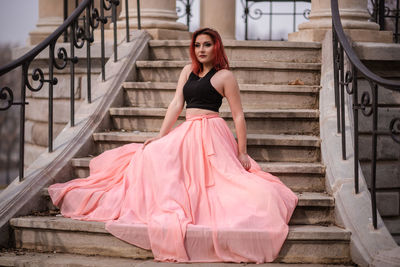 Portrait of young woman on staircase