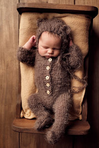 Portrait of cute baby boy sleeping in toy