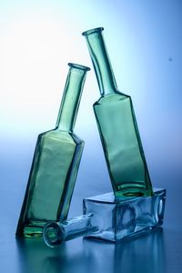 Close-up of glass bottle against blue background