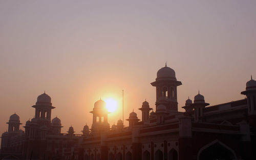 Buildings against sky during sunset