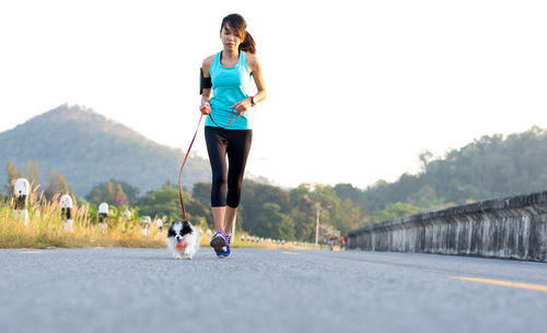 Full length of man with dog on road