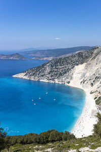 High angle view of sea shore against clear blue sky