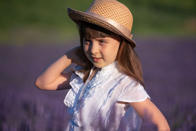 Portrait of cute girl standing on field