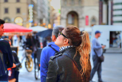 Woman looking at city street in winter