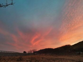 Scenic view of dramatic sky during sunset