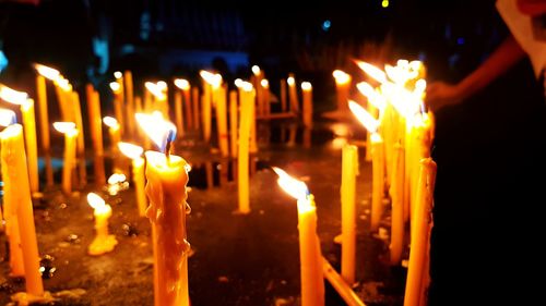 Close-up of lit candles in church