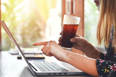 Midsection of woman using mobile phone