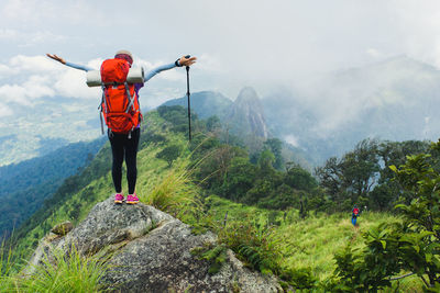 Full length of women climbing on mountain
