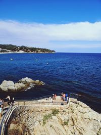 People on beach against sky