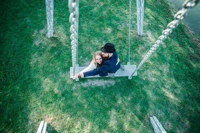 High angle view of person sitting on swing at playground