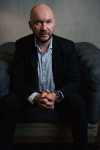 Portrait of businessman sitting on sofa